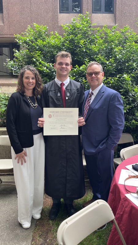 Coach at Harvard graduation with family