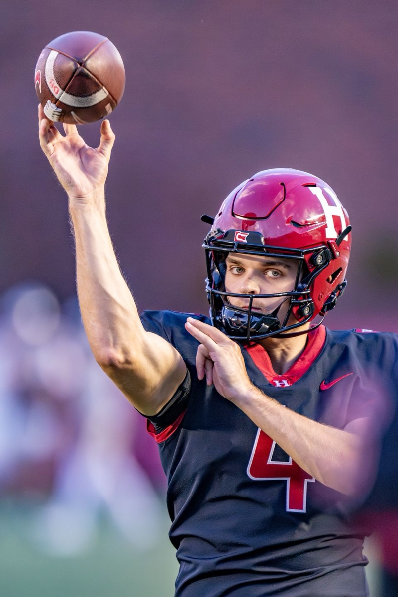 Coach throwing a pass at Harvard practice